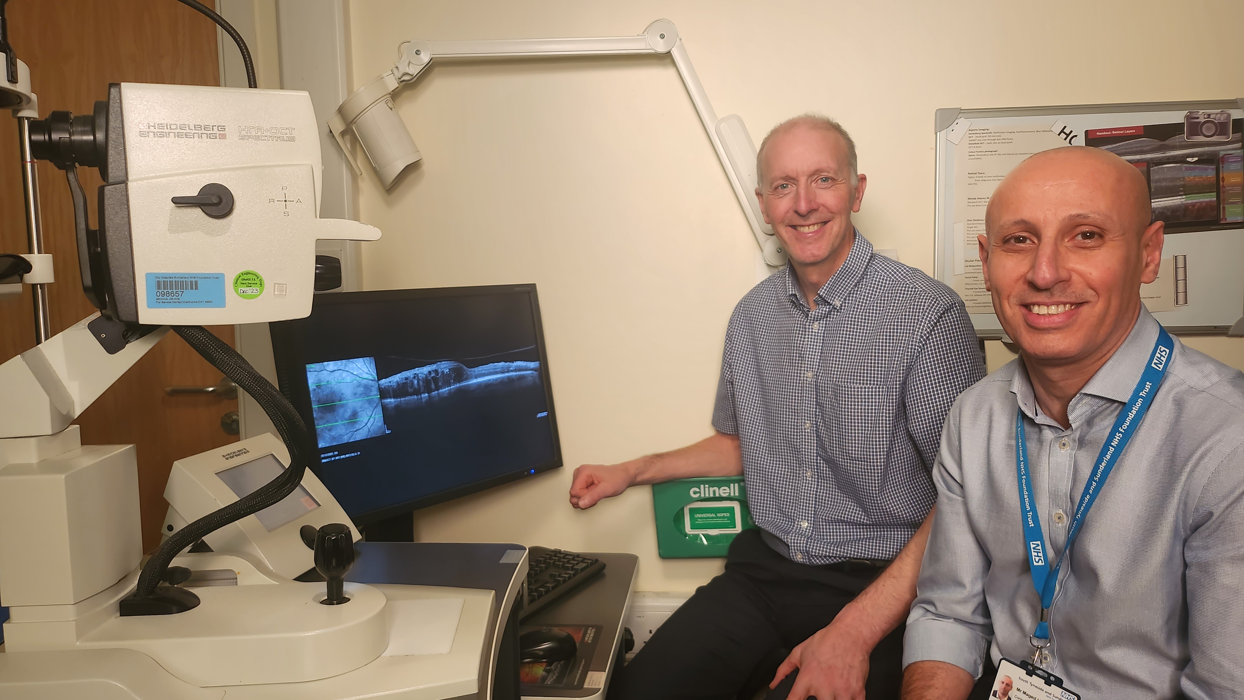 Professor David Steel and Mr Maged Habib review an image of a patient's eye as part of their research work into DMO..jpg